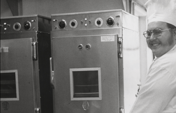 Chef standing next to original Cook & Hold oven in 1968