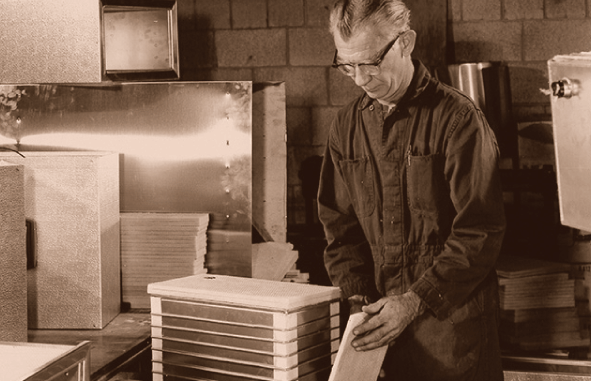 1960s shop worker readying product to be shipped.