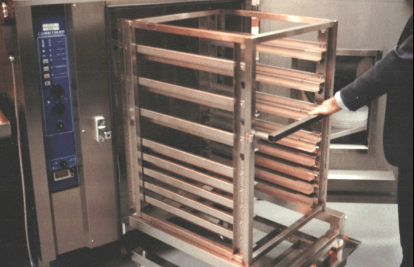 1990s rolling rack being pulled out of a combi oven