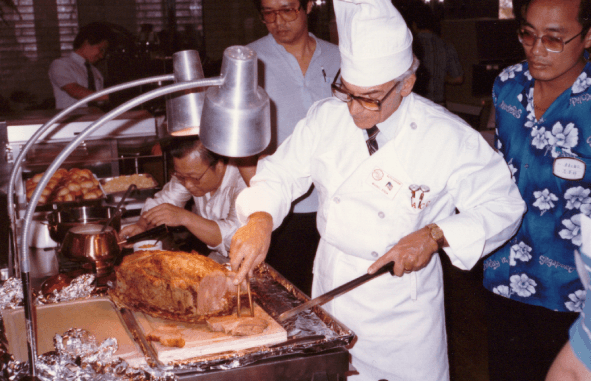 Chef carving meat at a carving station