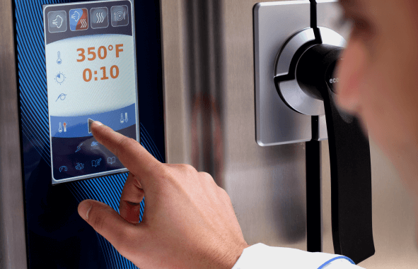 Finder pressing the control panel of a combination oven